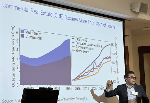 Photo of a researcher presenting during the 2025 Clark Research Symposium in the McDonough School of Business at Georgetown University.