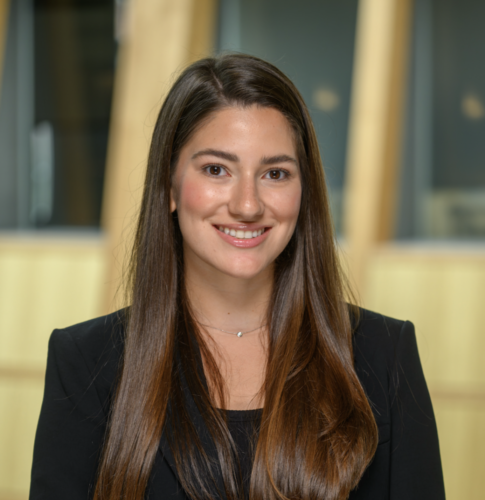 Steers student, Mariana Larach. Wearing a black suit jacket and a black dress shirt.