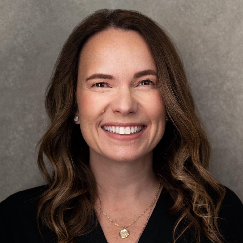 Headshot of Professor of the Practice and Head of Real Estate, Kelly Sewell Nagel, wearing a black business formal shirt.